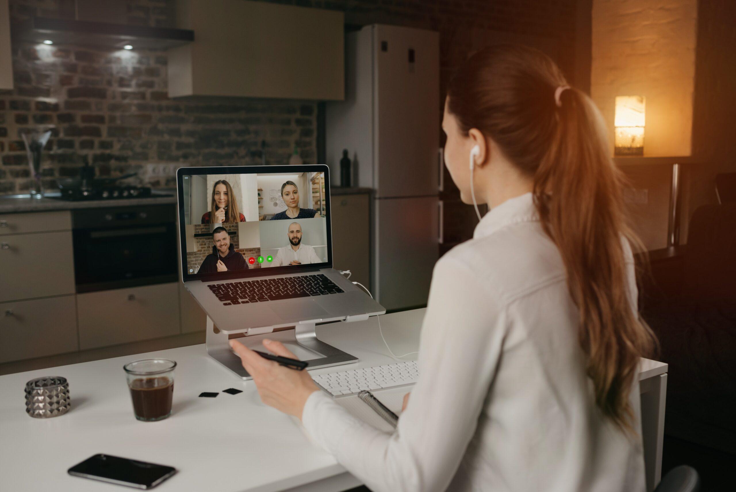 back-view-female-employee-working-remotely-talking-her-colleagues-about-business-video-conference-desktop-computer-home-multiethnic-business-team-online-meeting (1)