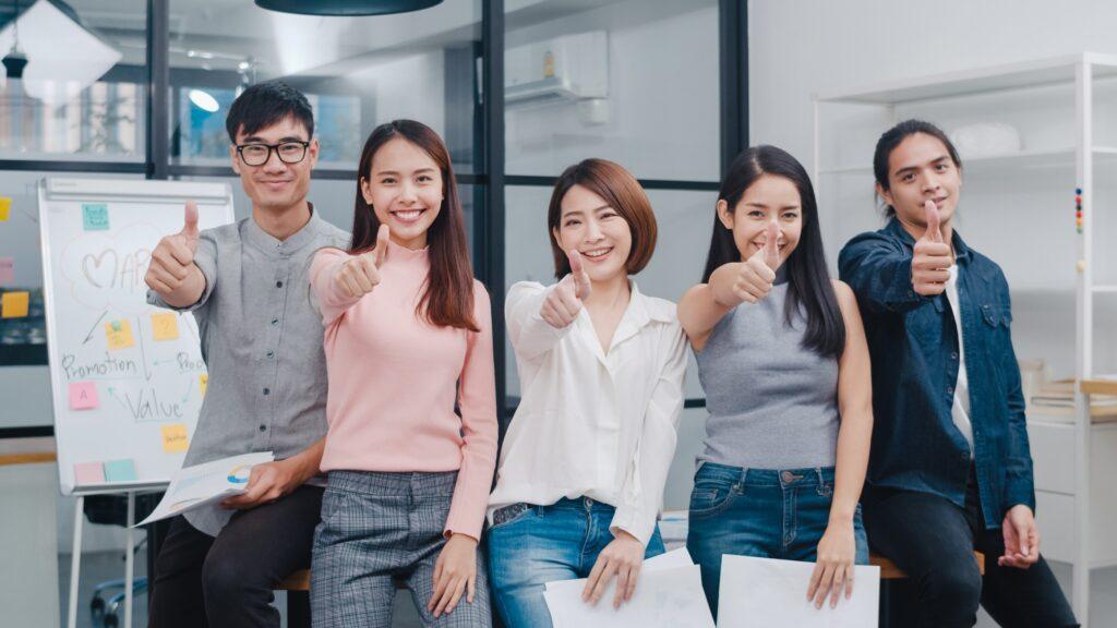 group-asia-young-creative-people-smart-casual-wear-smiling-thumbs-up-creative-office-workplace