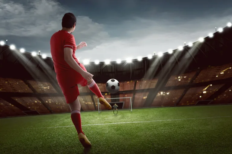 attractive-asian-football-player-shooting-ball-goal