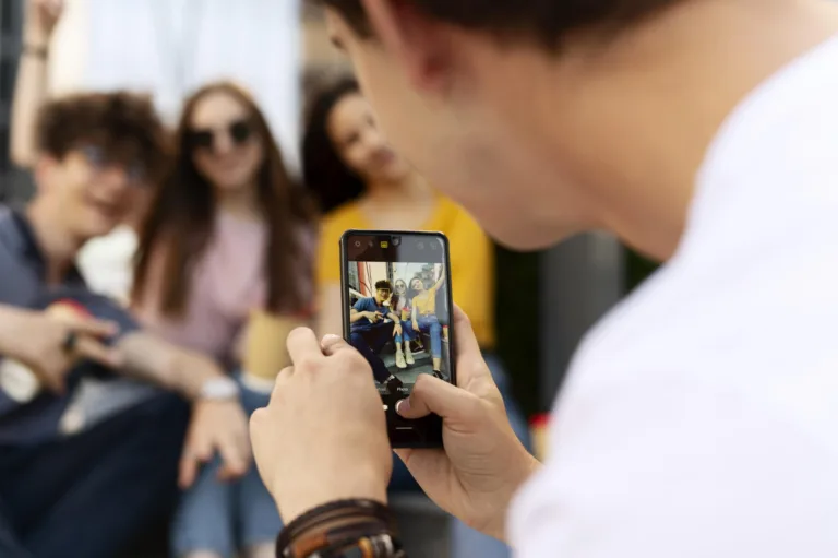 man-taking-photo-his-friends-while-outdoors