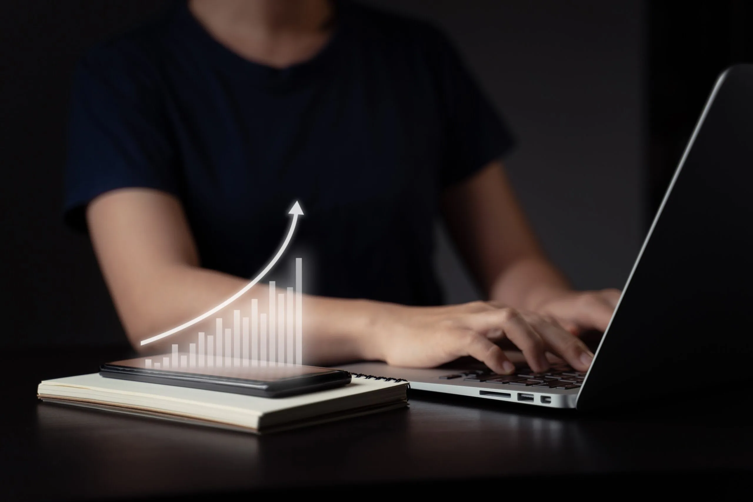 woman-using-laptop-planning-digital-marketing-with-chart-hologram-effect