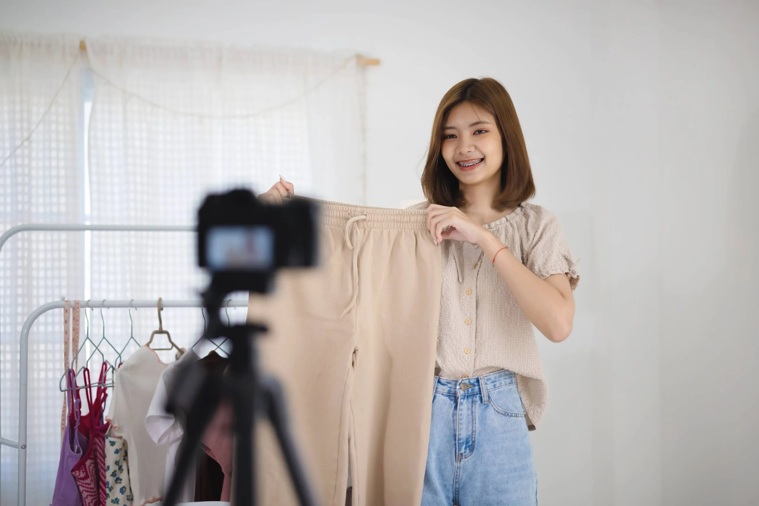 young-asian-seller-girl-showing-woman-clothes-making-video-live-streaming-online-home-online-market-with-social-media-concept