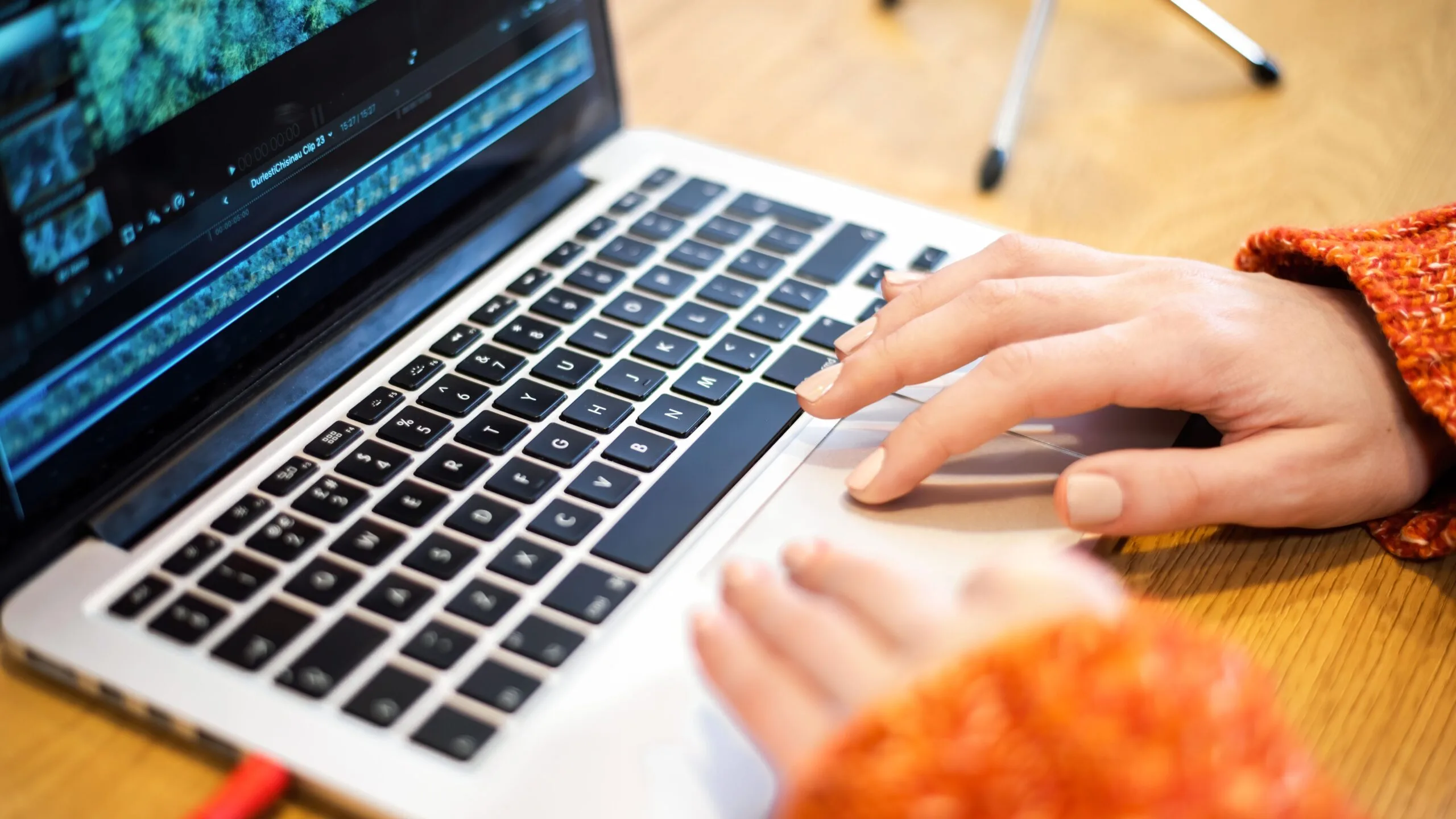 Woman-editing-video-her-laptop-microphone-table-working-from-home