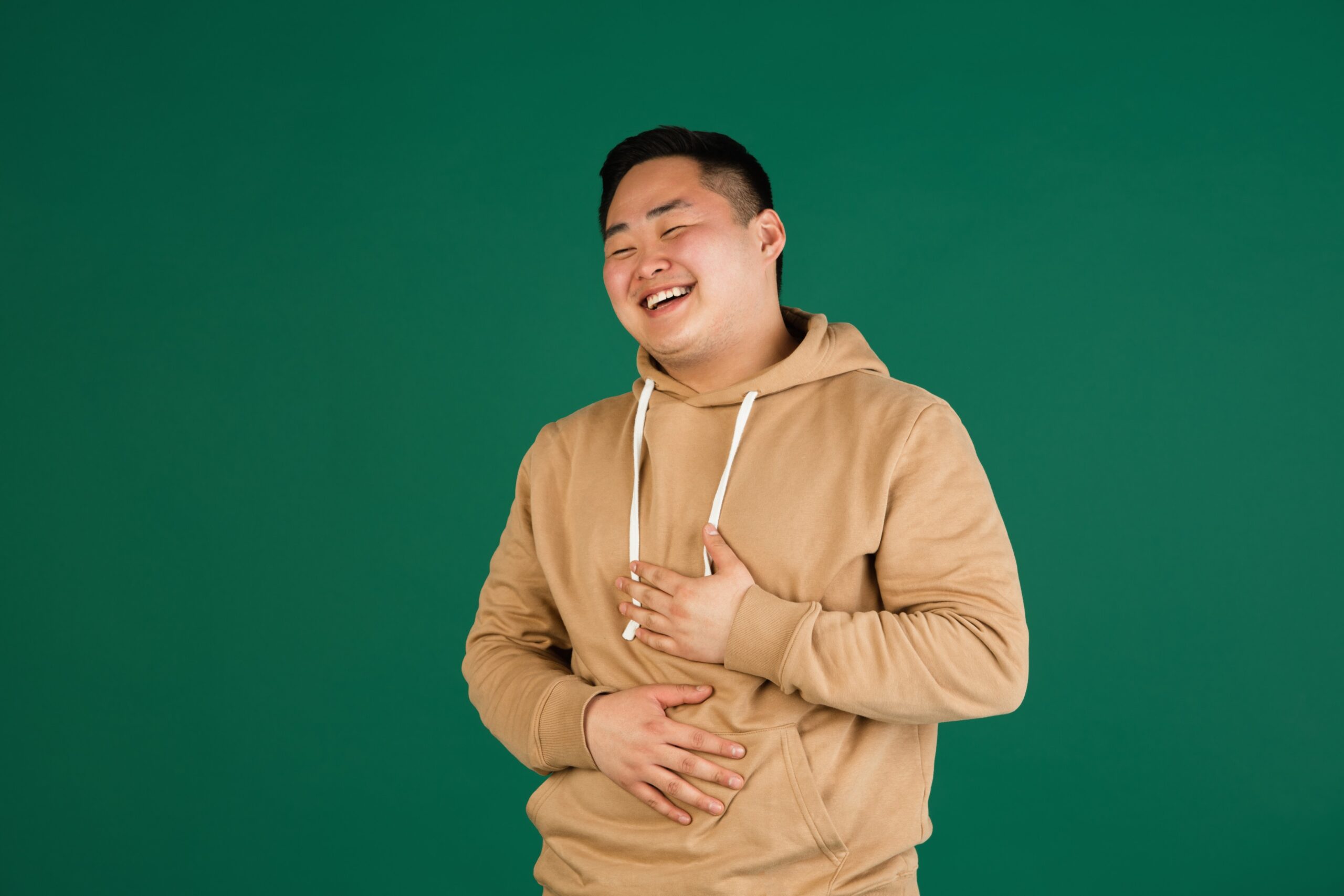 asian-man-s-portrait-isolated-green-studio-background-with-copyspace