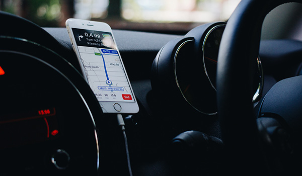 a-steering-wheel-with-a-phone-right-next-to-it