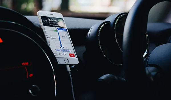 a-steering-wheel-with-a-phone-right-next-to-it