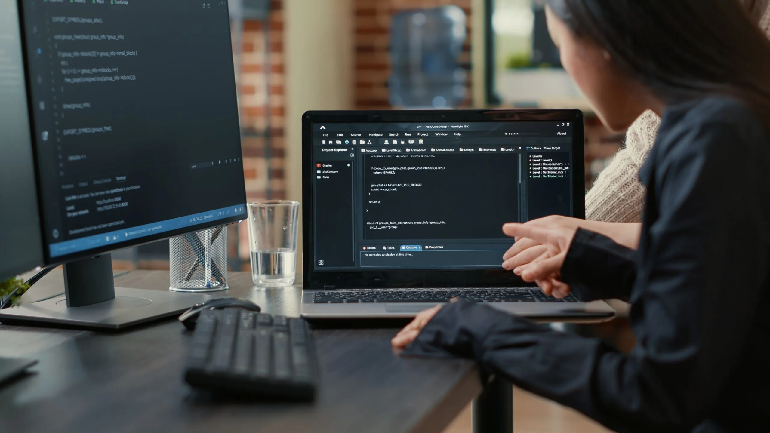 team-programmers-talking-about-algorithm-running-laptop-screen-pointing-source-code-while-sitting