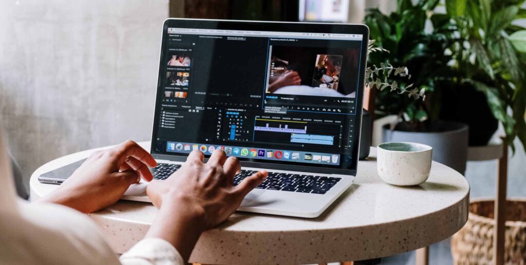 person working on video editing software on laptop