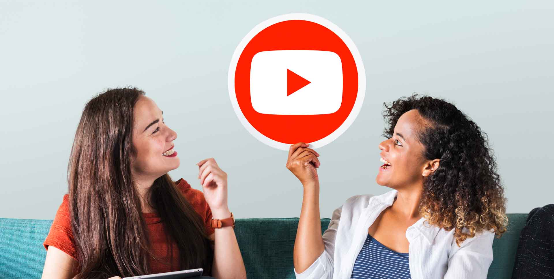 two women holding youtube logo picture