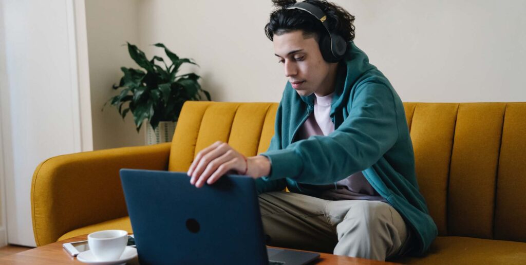 man using rapper voice synthesizer on laptop