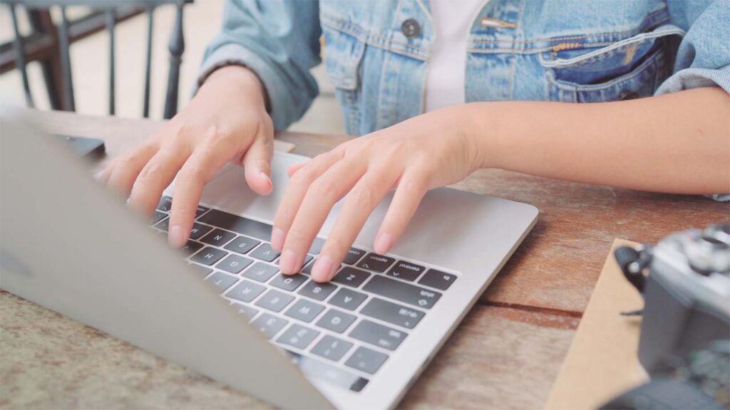 woman typing on laptop