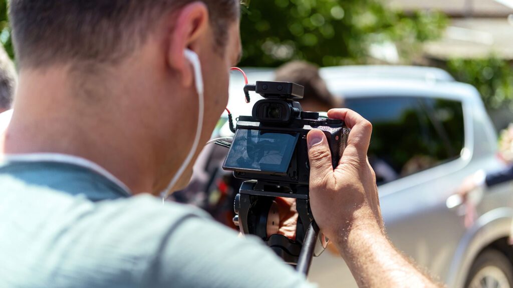 man filming video