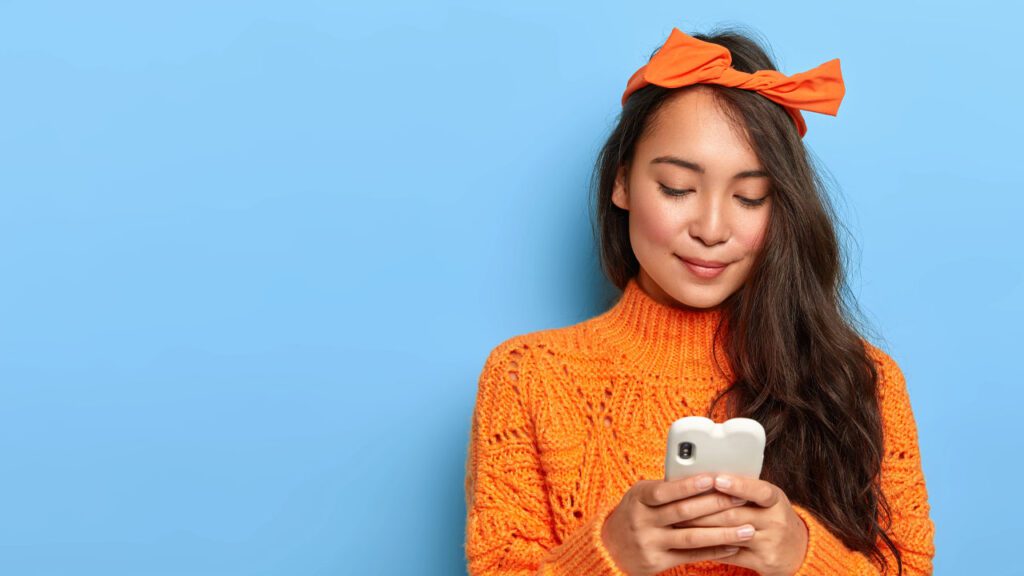 woman in orange on phone