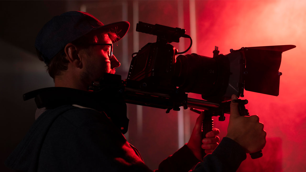 man holding camera in red light