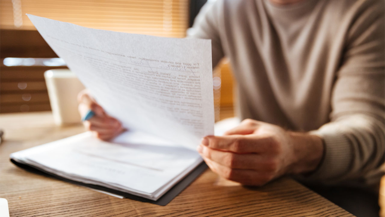 a man looking over a legal document