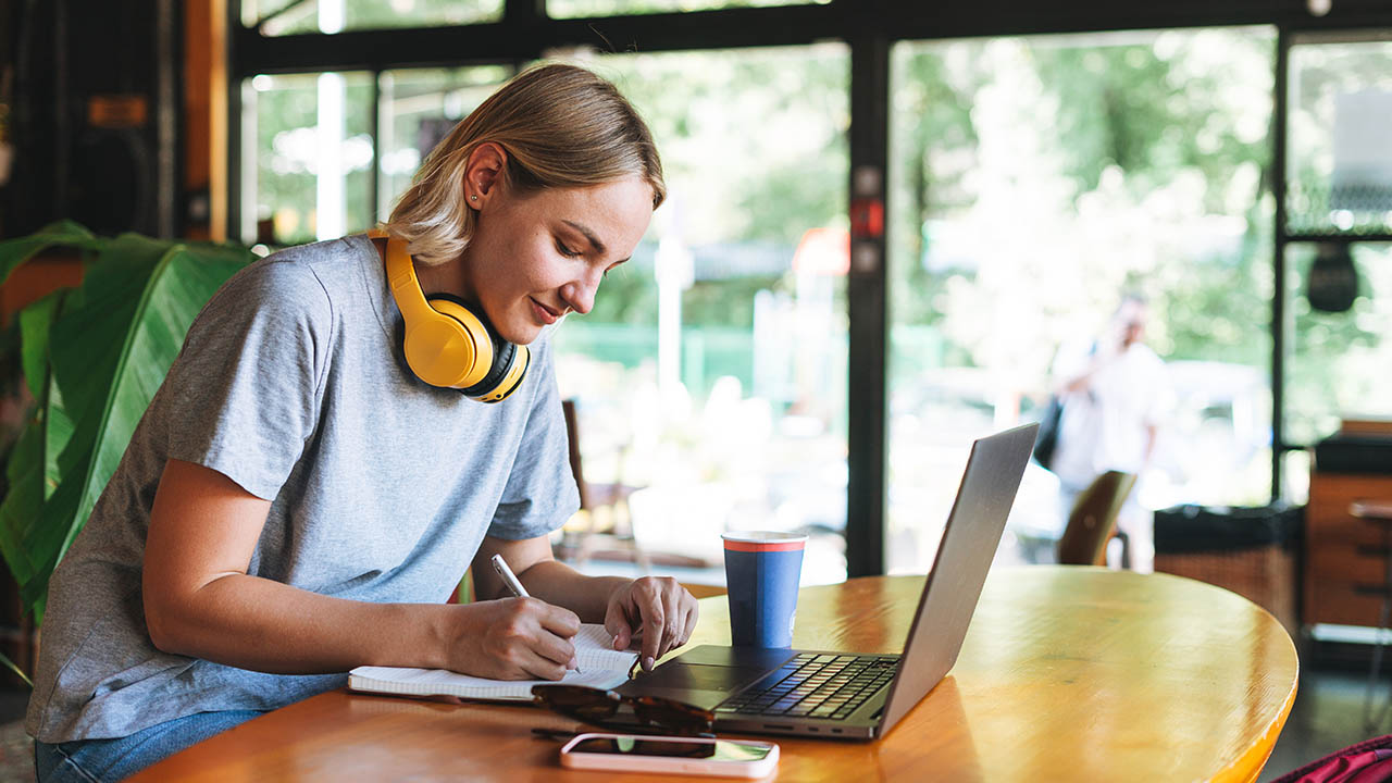 a girl with yellow headphones enjoying her eLearning classes