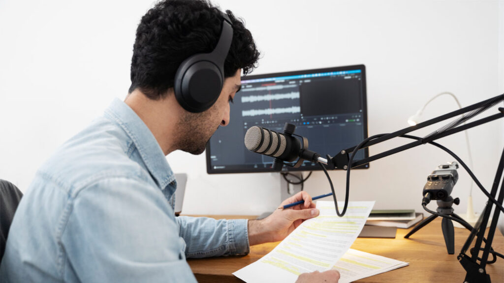 a creator recording a script at his desk using a voice changer tool