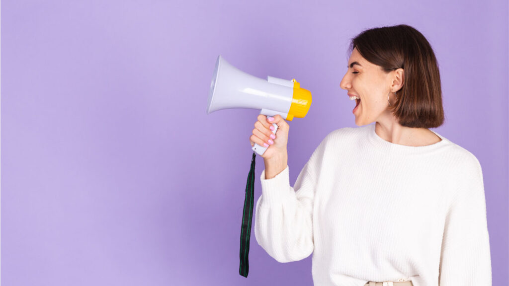 a woman speaking into a speaker