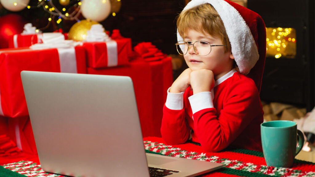 kid watching his typecast digital christmas card on a laptop