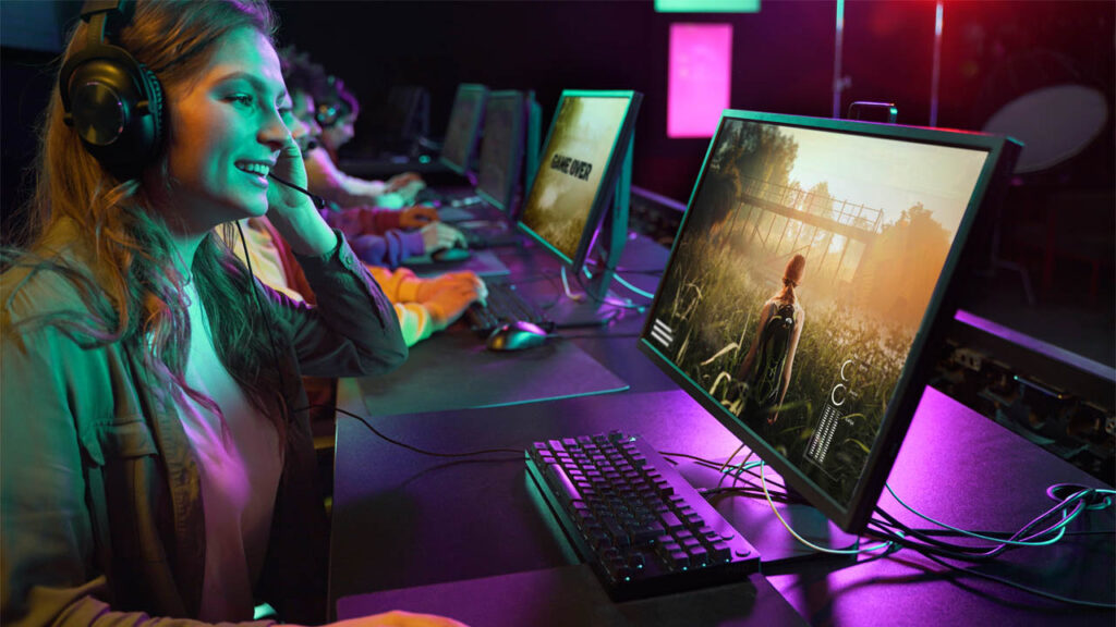 a young woman playing a video game on her PC and chatting with friends