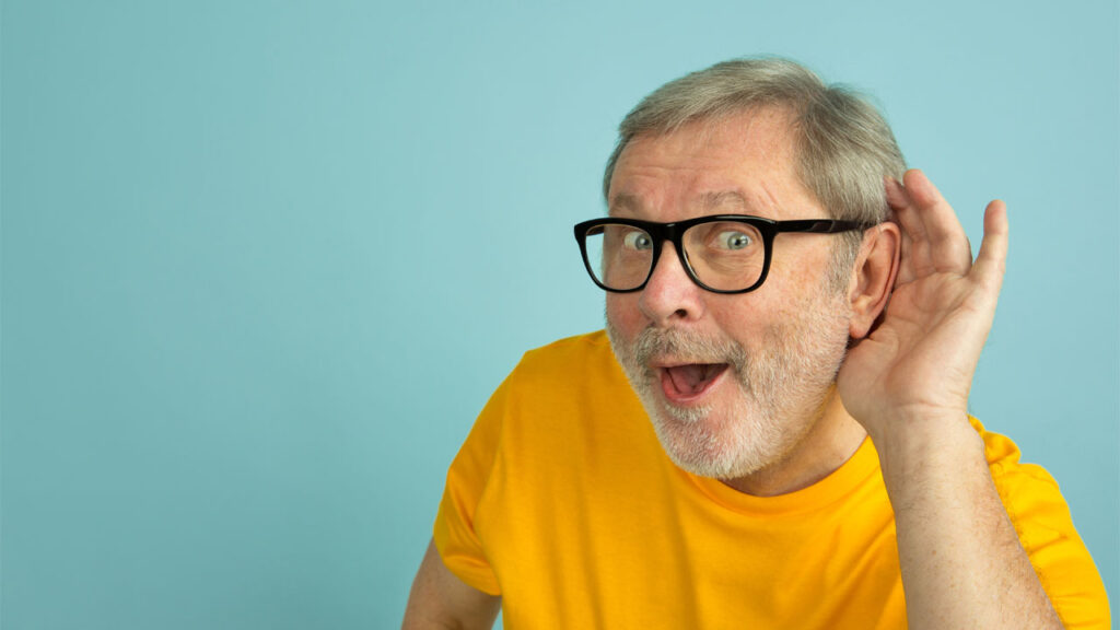 old man in yellow shirt listening to text to speech