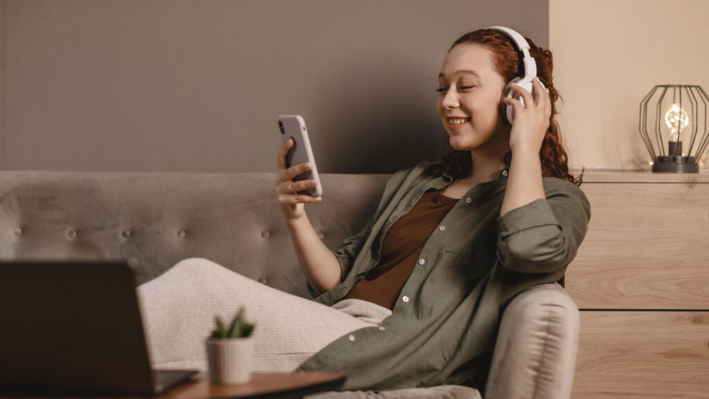 women listening to an audiobook made using text to speech technology