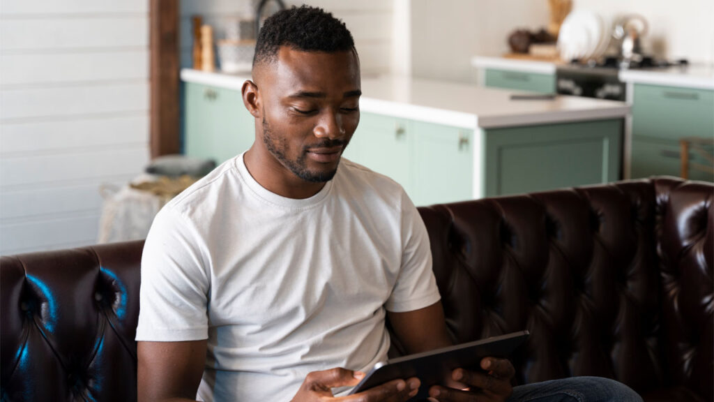 a man reading on his tablet using assistive technology