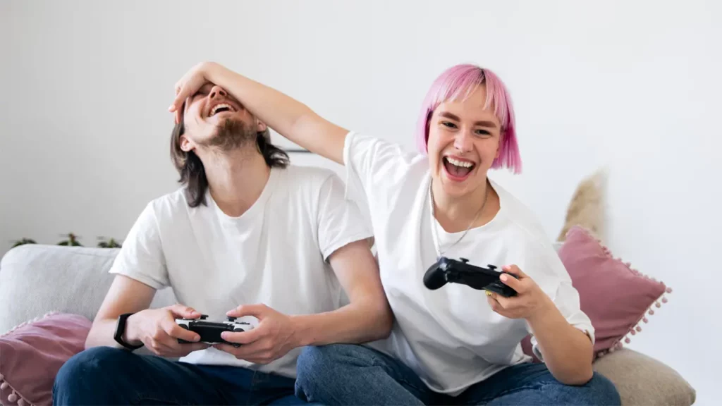 a young couple enjoying playing the playstation 5 together