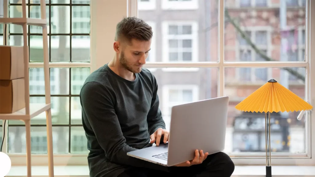 a man using a text to speech function on his macbook laptop