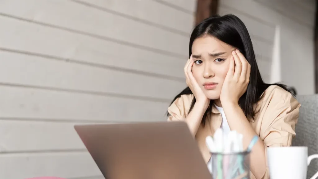 a woman frustrated with her laptop