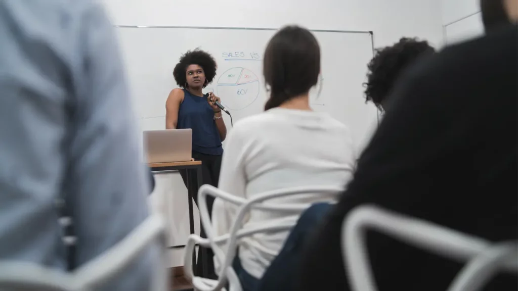 woman presenting in front of group