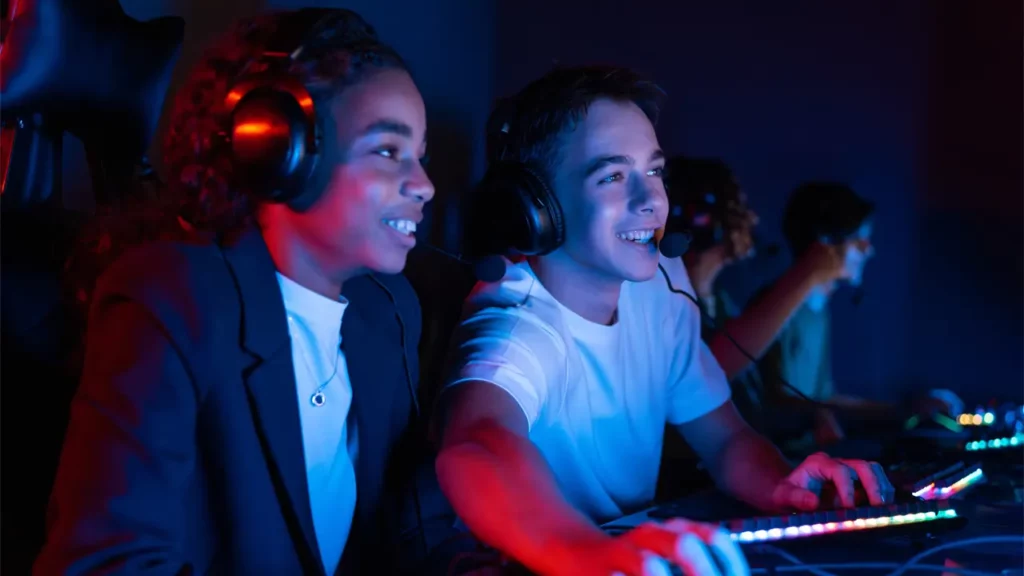 Two kids enjoying a video game together.