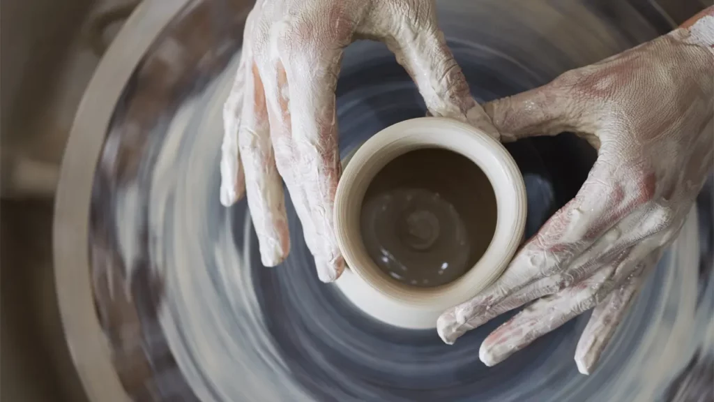 Someone creating pottery.
