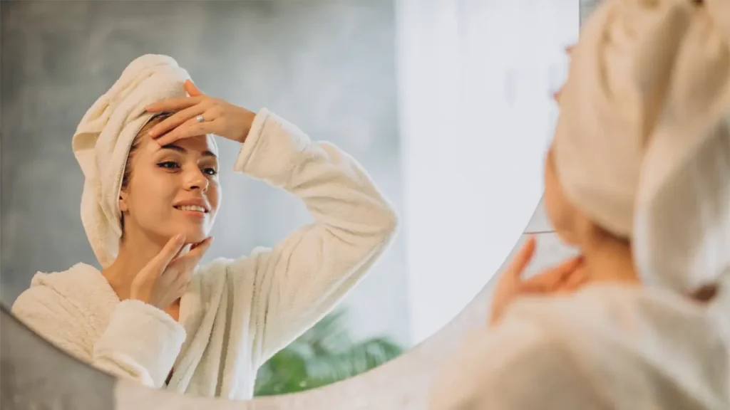 A woman applying her skincare routine.