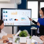 woman presenting in front of company