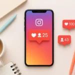 A smartphone displaying the Instagram app with like and comment notifications on a desk with a notebook and pens.