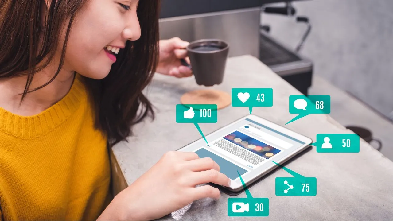 Person using a tablet with social media engagement icons.