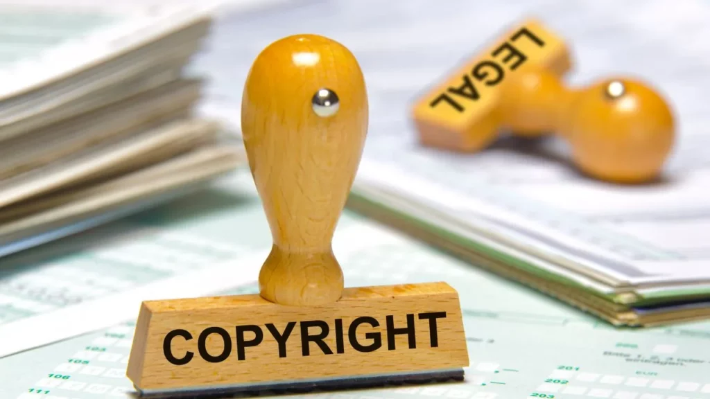 Wooden stamp with "COPYRIGHT" text on paperwork.