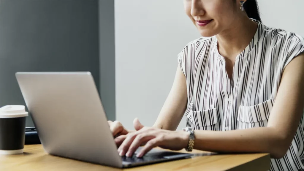 A woman working on her MacBook.