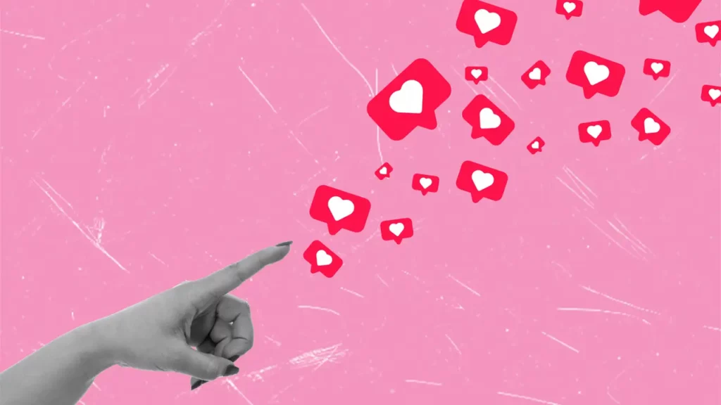A hand pointing towards floating heart emojis.