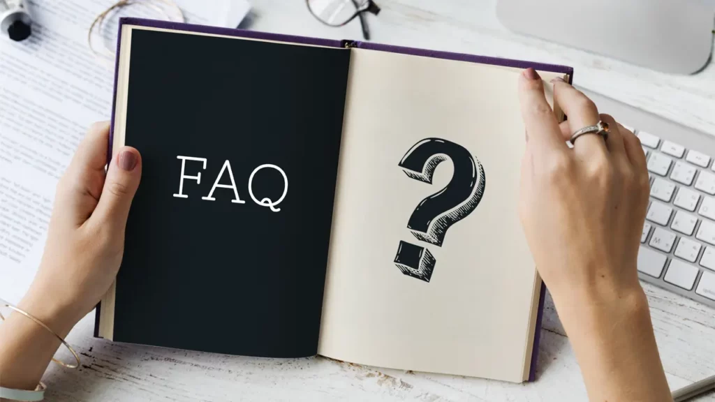 A book with the word "FAQ," and a question mark printed inside on the pages.