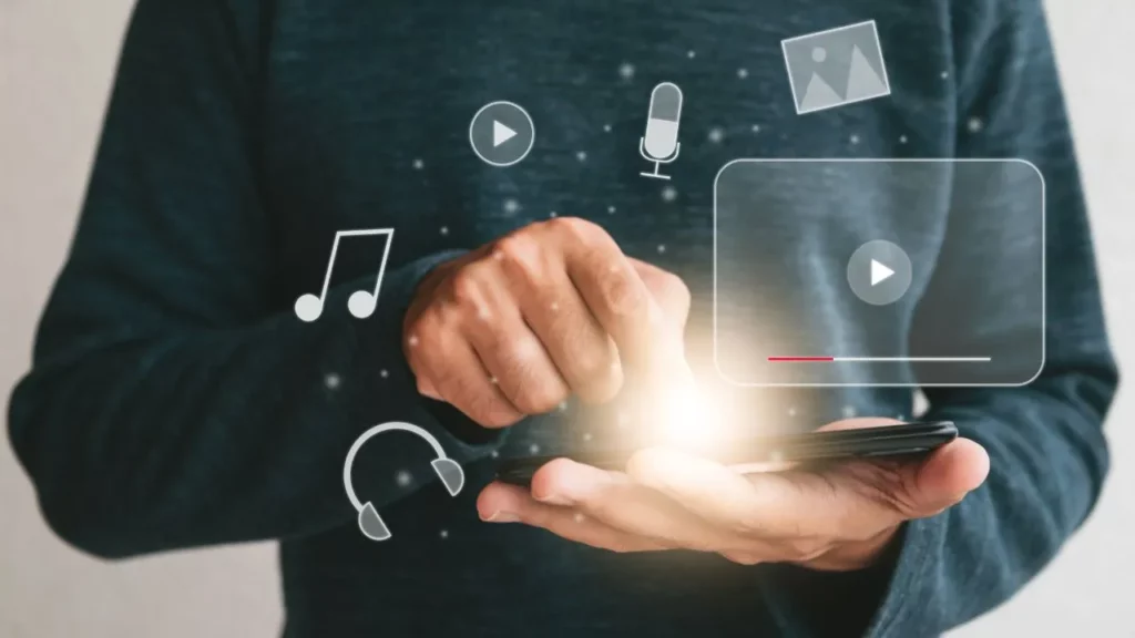 Person holding a smartphone with multimedia icons and a video player interface.