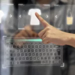 Hand interacting with a holographic interface showing clothing items like a white t-shirt and a beige handbag above a projected keyboard.