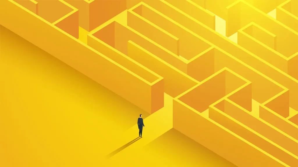 A man standing outside a complex maze.