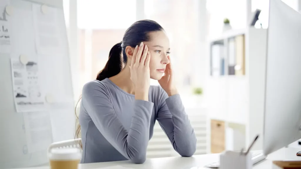 A woman at her desk worrying about potential mistakes.