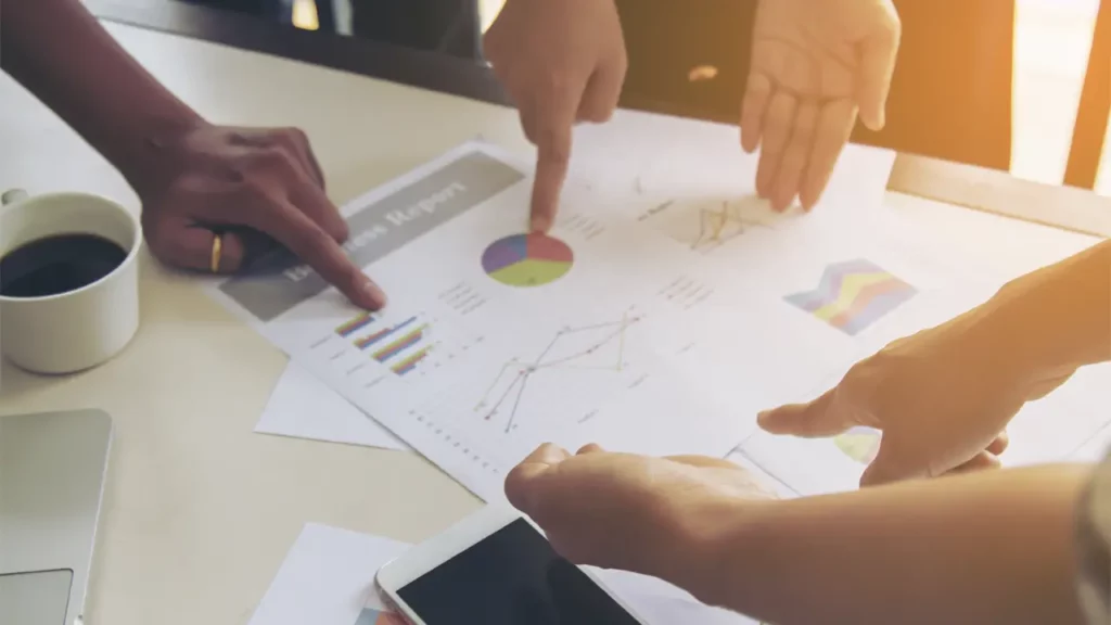 A group of people discussing marketing data.