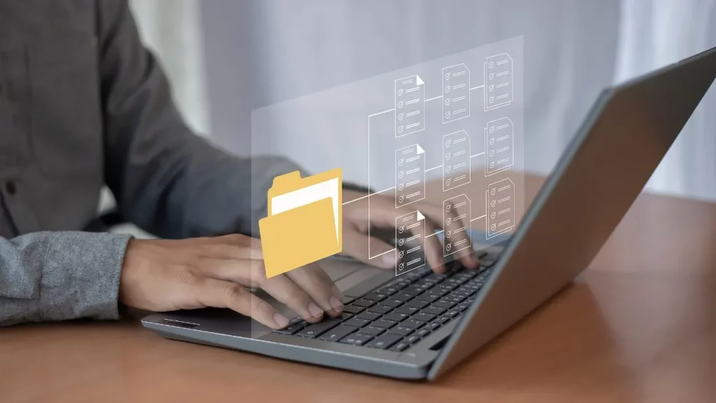 A person typing on a laptop with a digital overlay showing a file folder and document hierarchy.