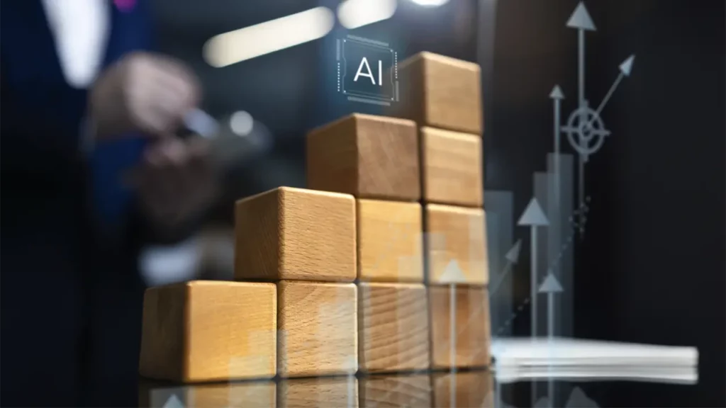 A stack of wooden blocks with an AI symbol at the top, signifying progress.