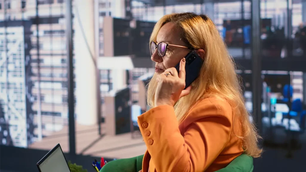 A woman listening to an AI chatbot on her phone.