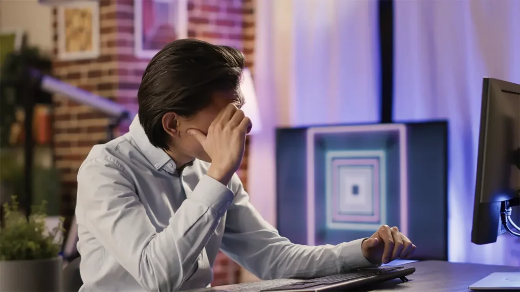 A concerned man using his computer.